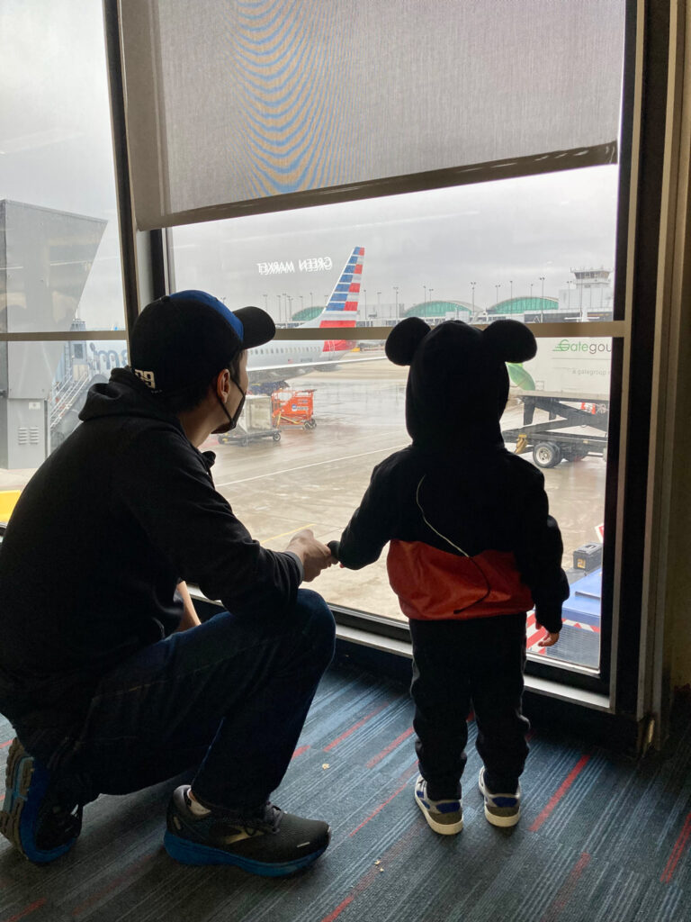 Dad and son looking through airport window